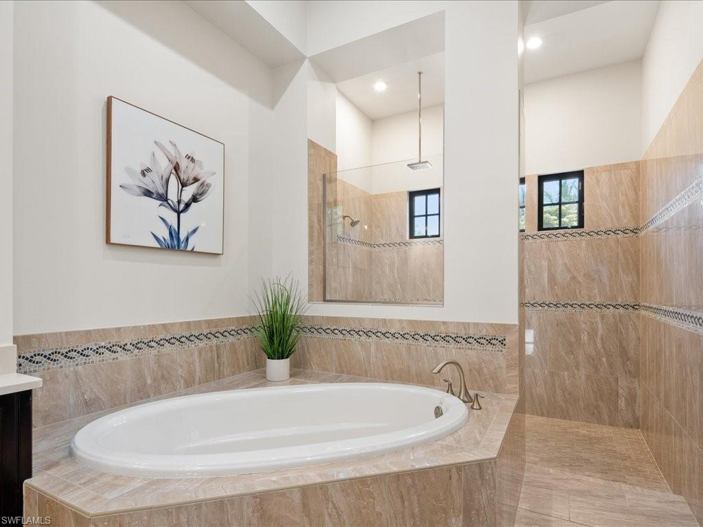 4249 Deephaven Lane Naples, FL 34119 - Photo 35 of 50 a bathroom with a tub and a shower
