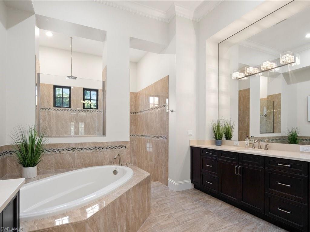 4249 Deephaven Lane Naples, FL 34119 - Photo 36 of 50 a bathroom with a tub a sink and mirror