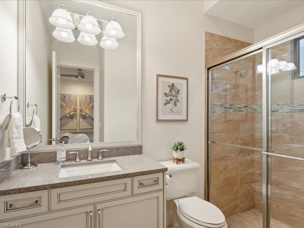4249 Deephaven Lane Naples, FL 34119 - Photo 38 of 50 a bathroom with a sink a toilet and a mirror