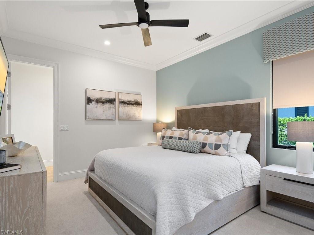 4249 Deephaven Lane Naples, FL 34119 - Photo 39 of 50 a bedroom with a bed and lamp