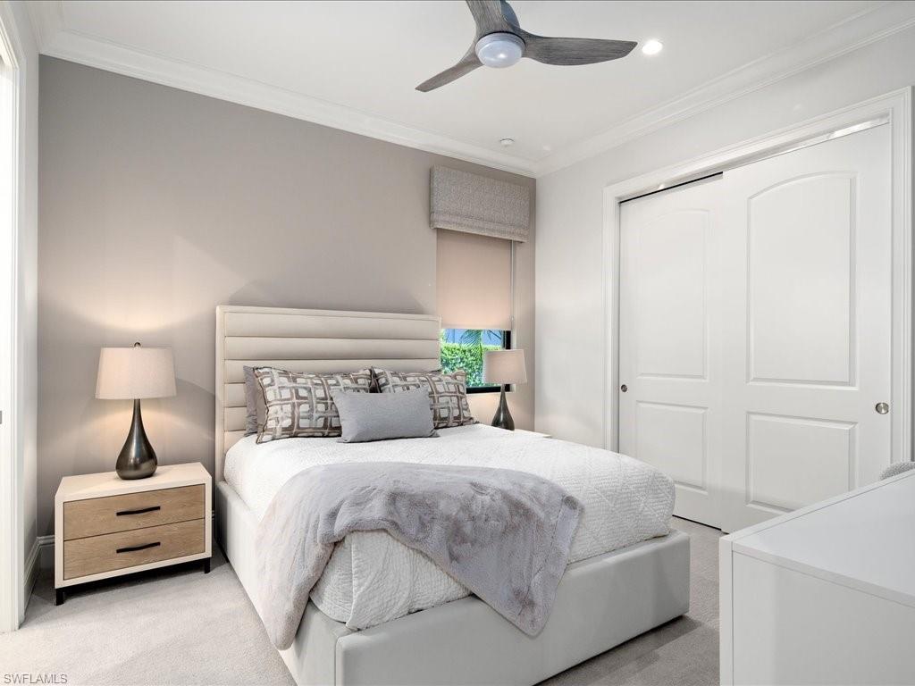 4249 Deephaven Lane Naples, FL 34119 - Photo 41 of 50 a bedroom with a bed and a chandelier