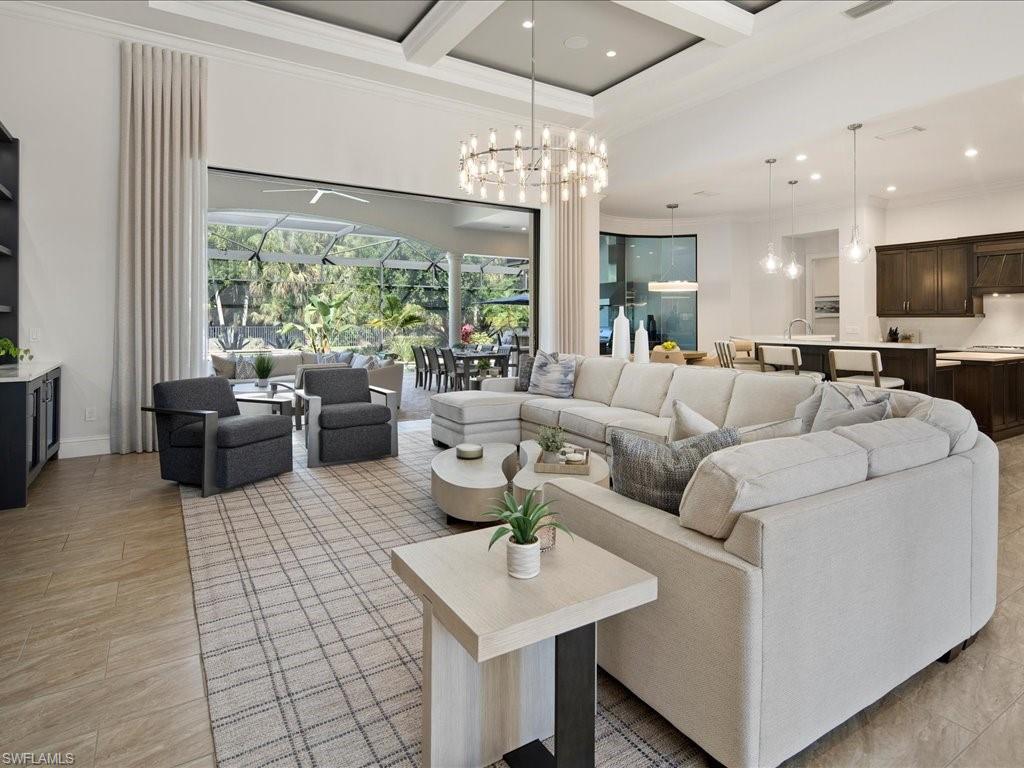 4249 Deephaven Lane Naples, FL 34119 - Photo 5 of 50 a living room with fireplace furniture and a large window