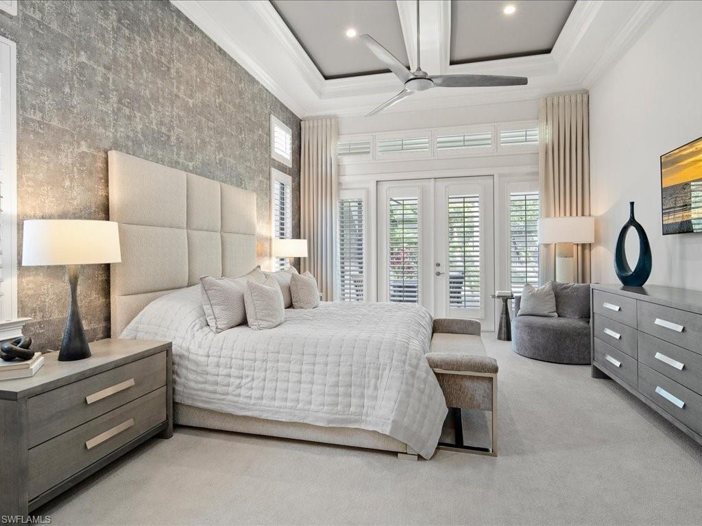 4249 Deephaven Lane Naples, FL 34119 - Photo 10 of 50 a bedroom with a large bed and a night stand next to a window