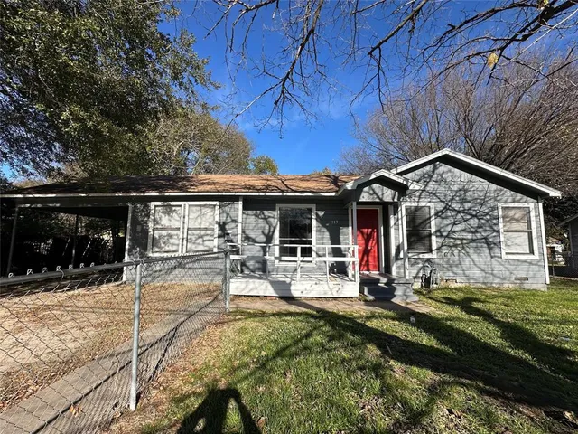 a view of a house with floor to ceiling windows and a basket ball poll