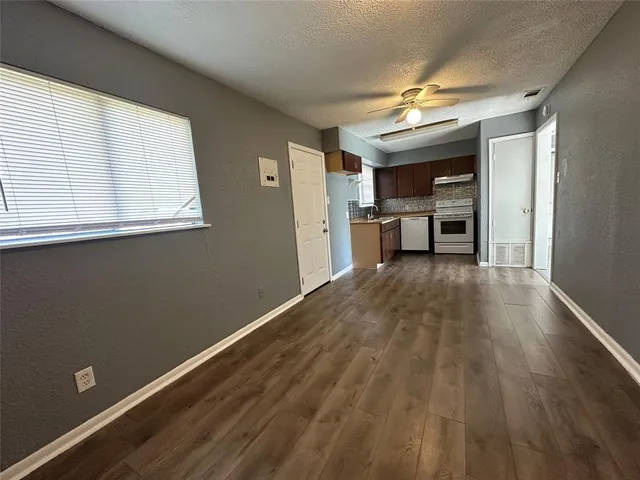 a view of a kitchen from the hallway