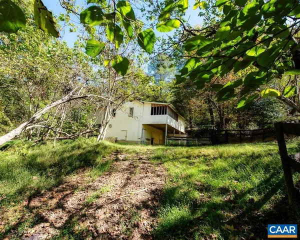 a small barn in middle of the green field