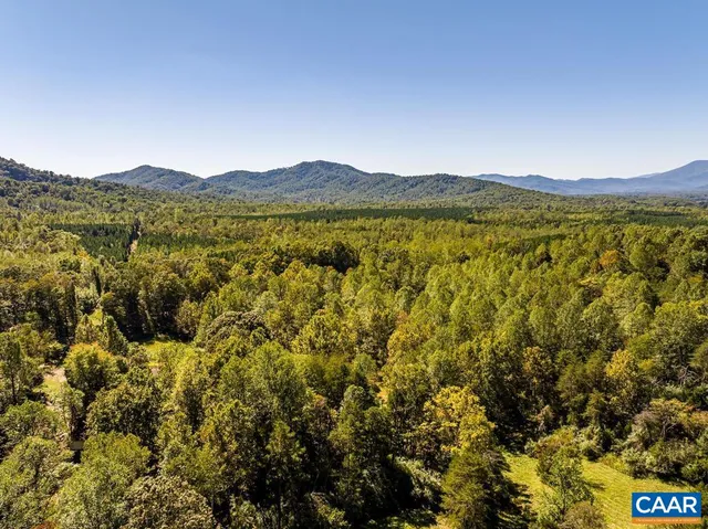 a view of house with backyard and garden