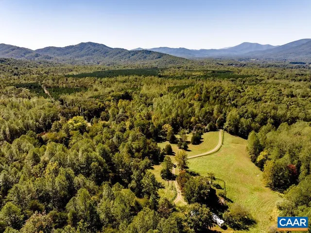 a backyard of a house with a yard and outdoor seating