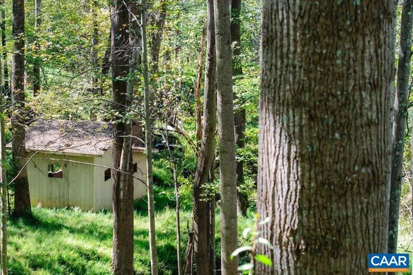 a view of house with backyard and garden