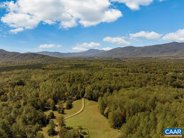 an aerial view of a houses with yard