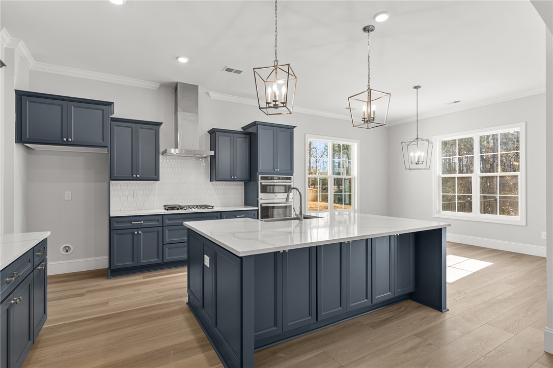 141 Rickys Path Easley, SC 29642 - Photo 9 of 40 This kitchen features a spacious island, clean countertops, and modern appliances perfect for daily living.
