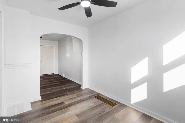 wooden floor in an empty room with a window