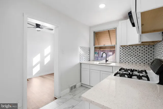 a kitchen with a sink appliances and cabinets