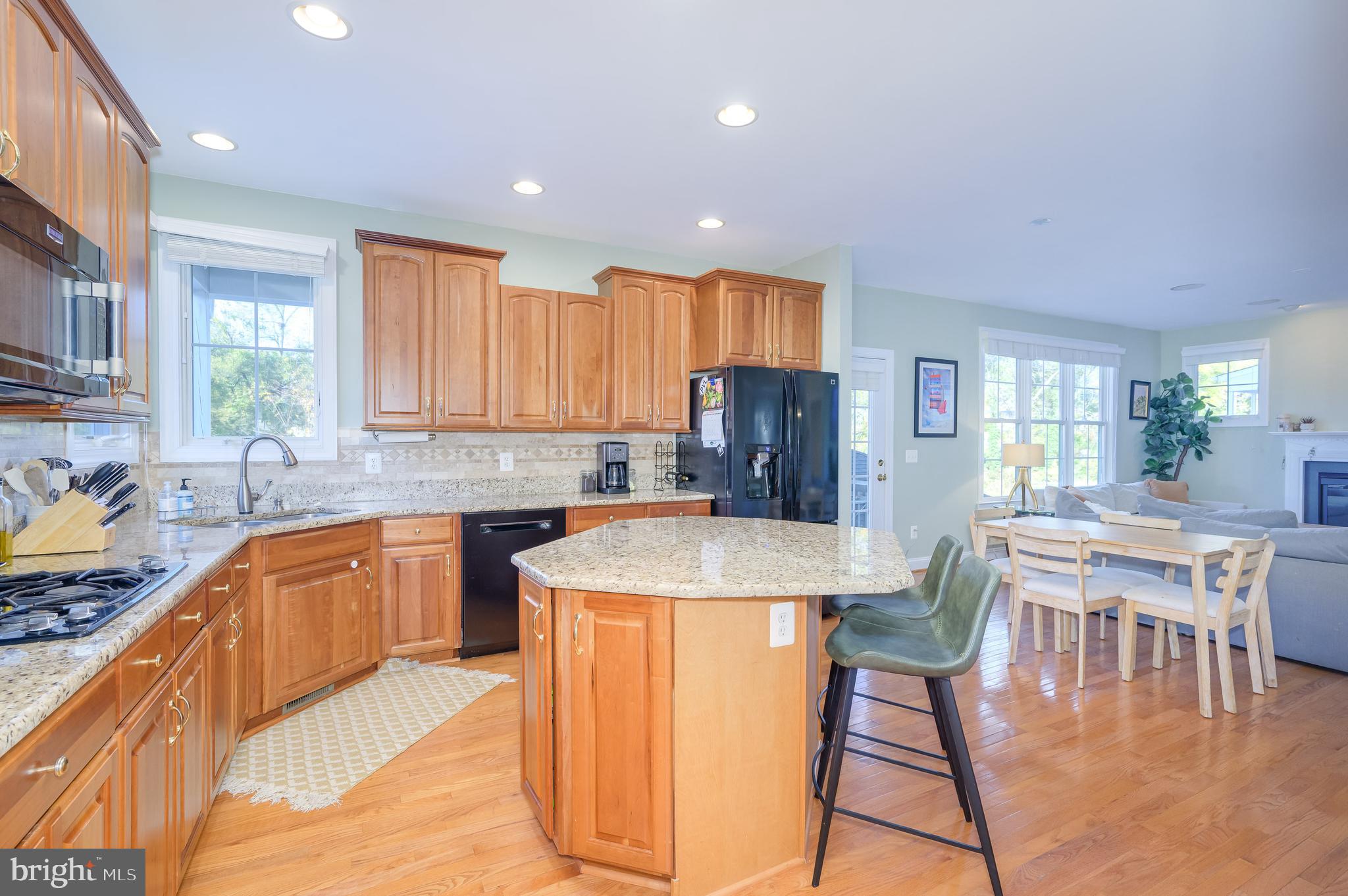 109 Amalfi Court Purcellville, VA 20132 - Photo 11 of 65 a kitchen with stainless steel appliances granite countertop a stove a sink a refrigerator a dining table and chairs
