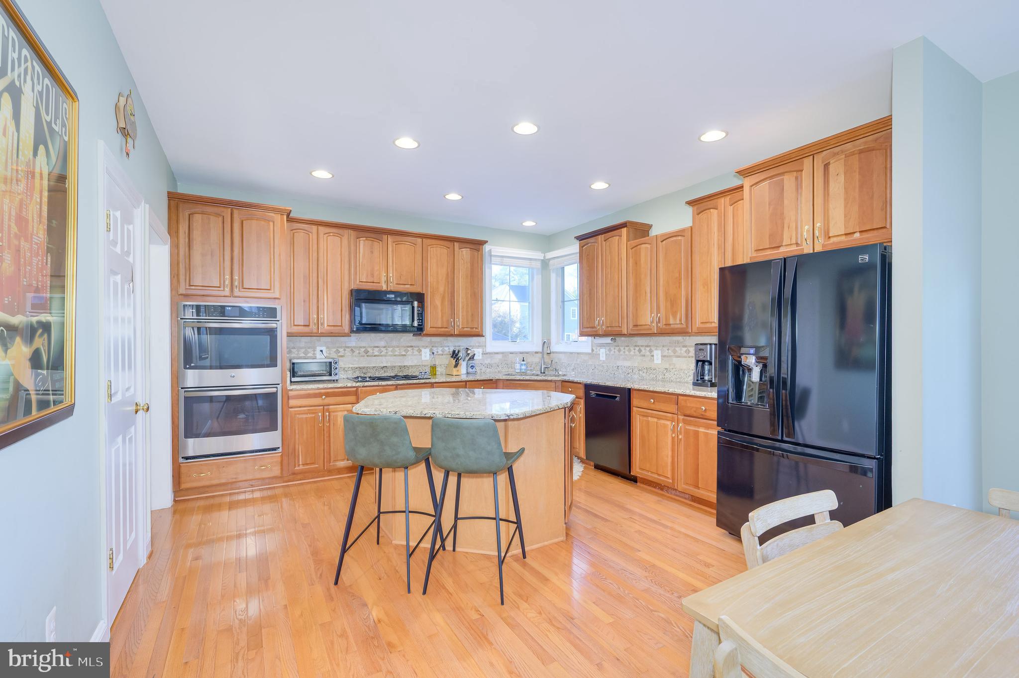 109 Amalfi Court Purcellville, VA 20132 - Photo 13 of 65 a kitchen with stainless steel appliances granite countertop a refrigerator a stove top oven and a sink with cabinets