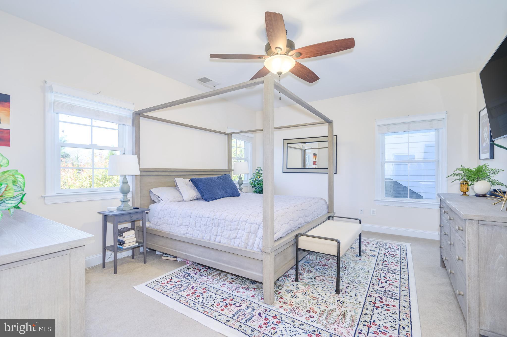 109 Amalfi Court Purcellville, VA 20132 - Photo 26 of 65 a bedroom with a bed chandelier and a window