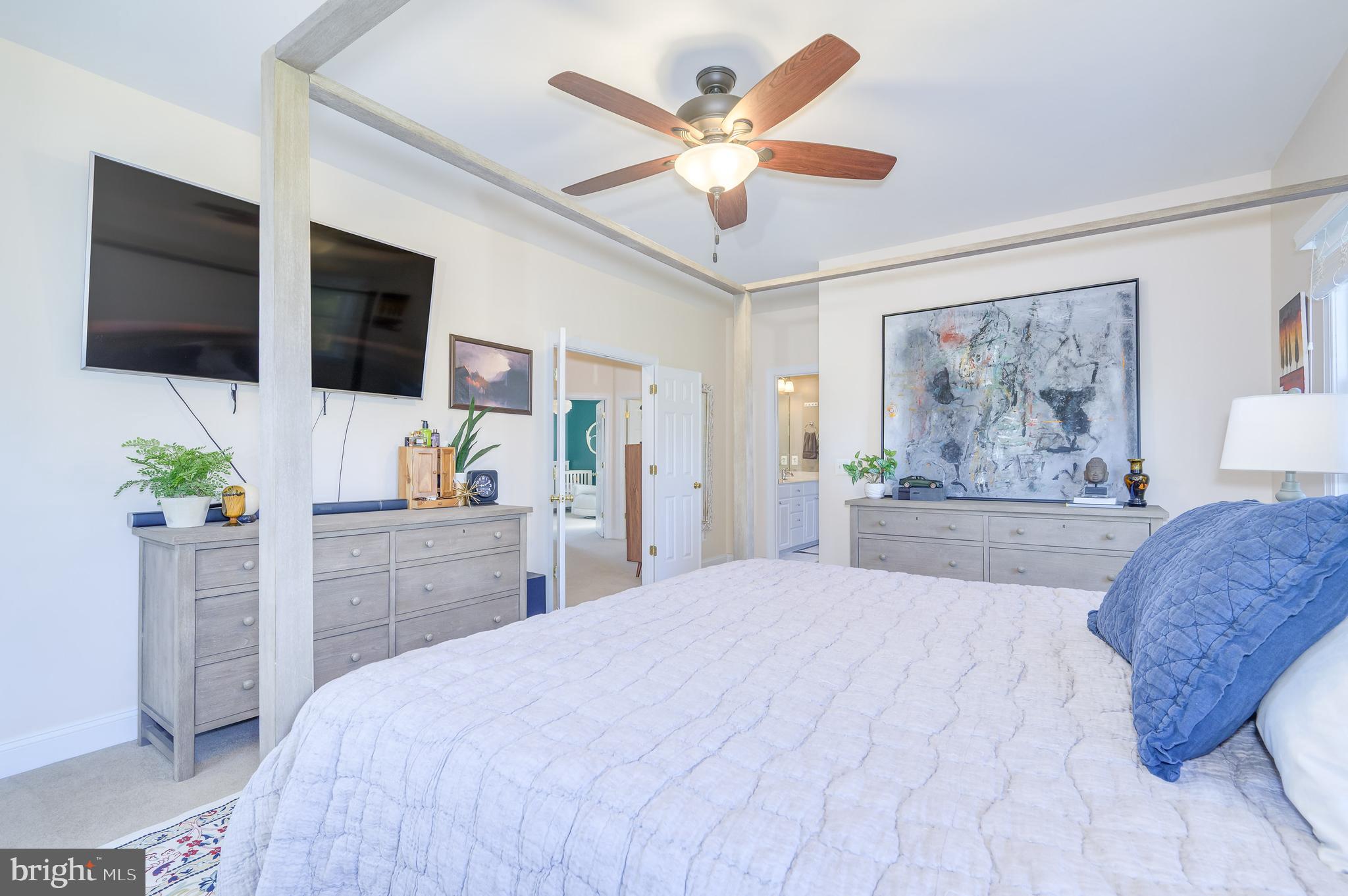 109 Amalfi Court Purcellville, VA 20132 - Photo 27 of 65 a bedroom with a large bed and a flat screen tv