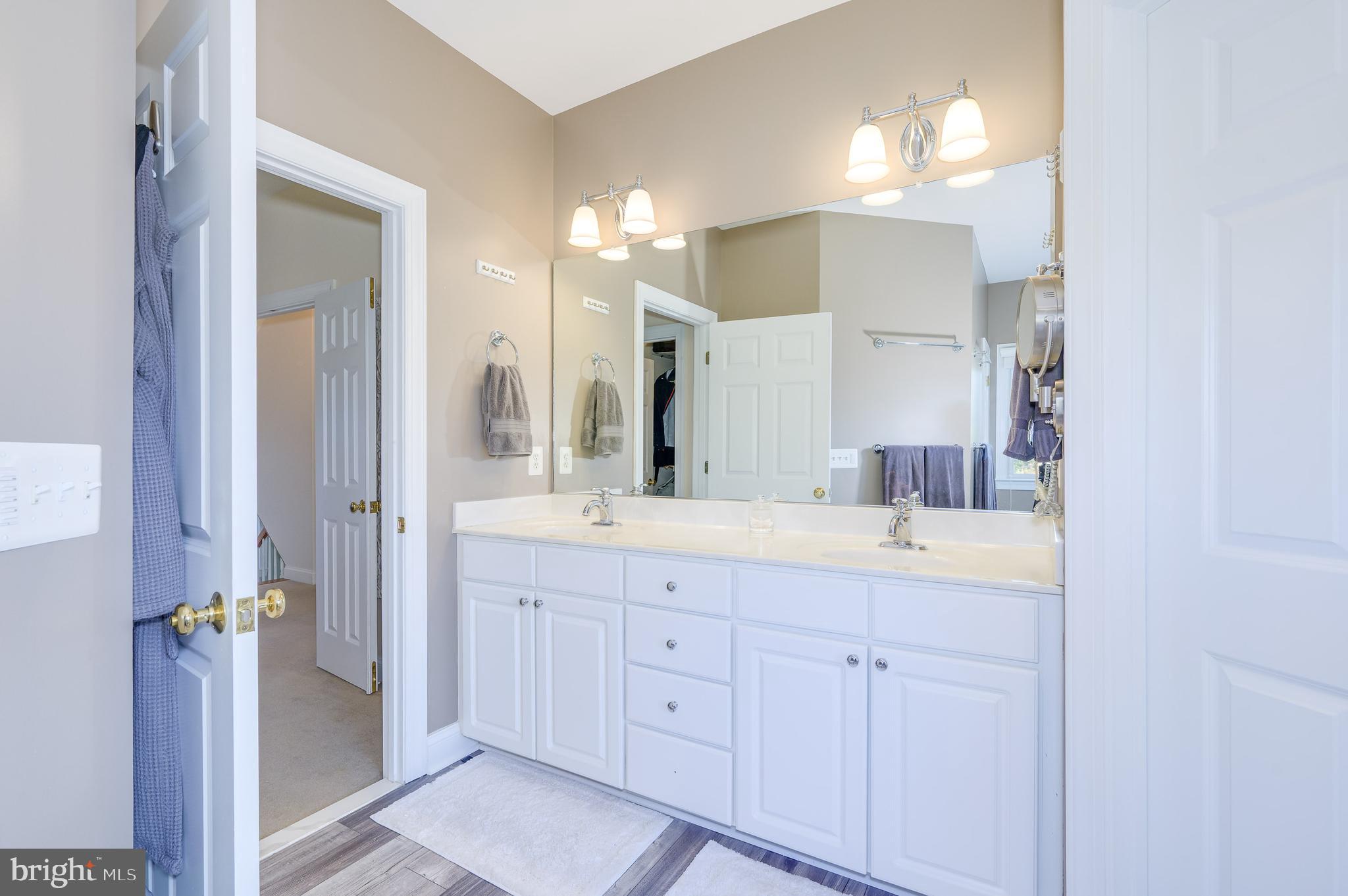 109 Amalfi Court Purcellville, VA 20132 - Photo 41 of 65 a spacious bathroom with a double vanity sink and mirror