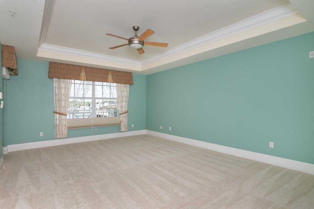 2240 Front Street, Unit 103 Melbourne, FL 32901 - Photo 14 of 37 an empty room with windows and fan