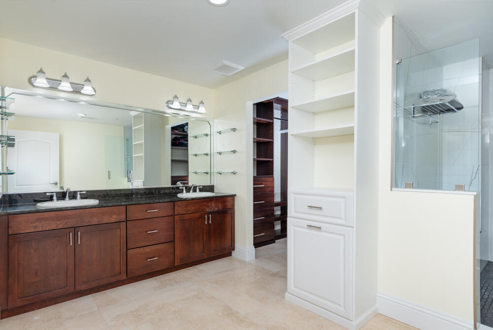 2240 Front Street, Unit 103 Melbourne, FL 32901 - Photo 16 of 37 a spacious bathroom with a double vanity sink a large mirror and a shower