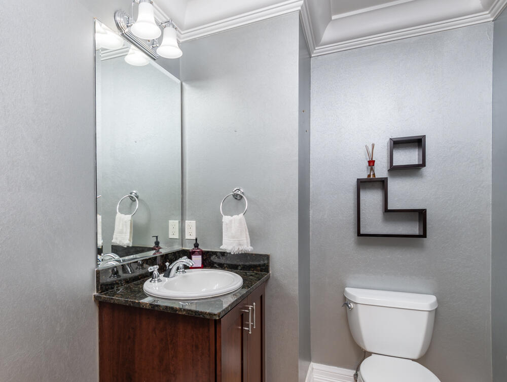 2240 Front Street, Unit 103 Melbourne, FL 32901 - Photo 23 of 37 a bathroom with a toilet sink and mirror