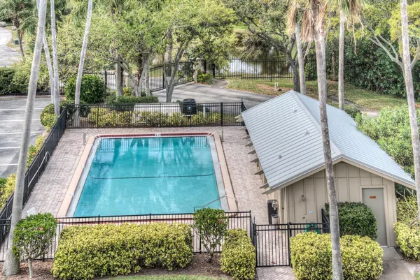 swimming pool view with a garden space