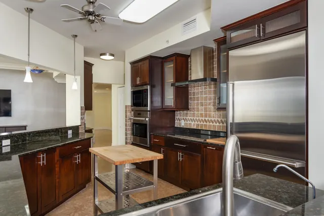 a kitchen with a sink cabinets and stainless steel appliances