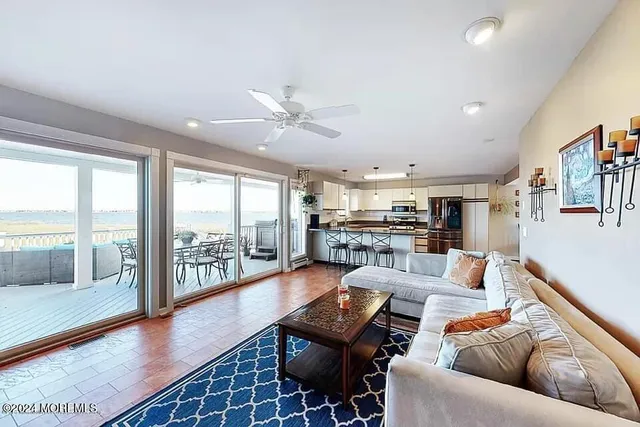 a living room with furniture and a floor to ceiling window
