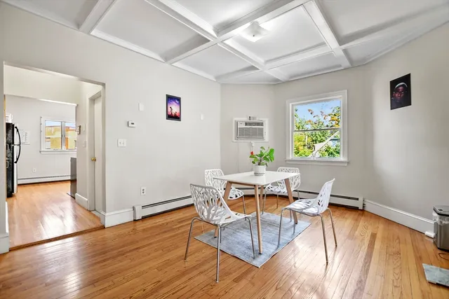 a workspace with furniture wooden floor and a window