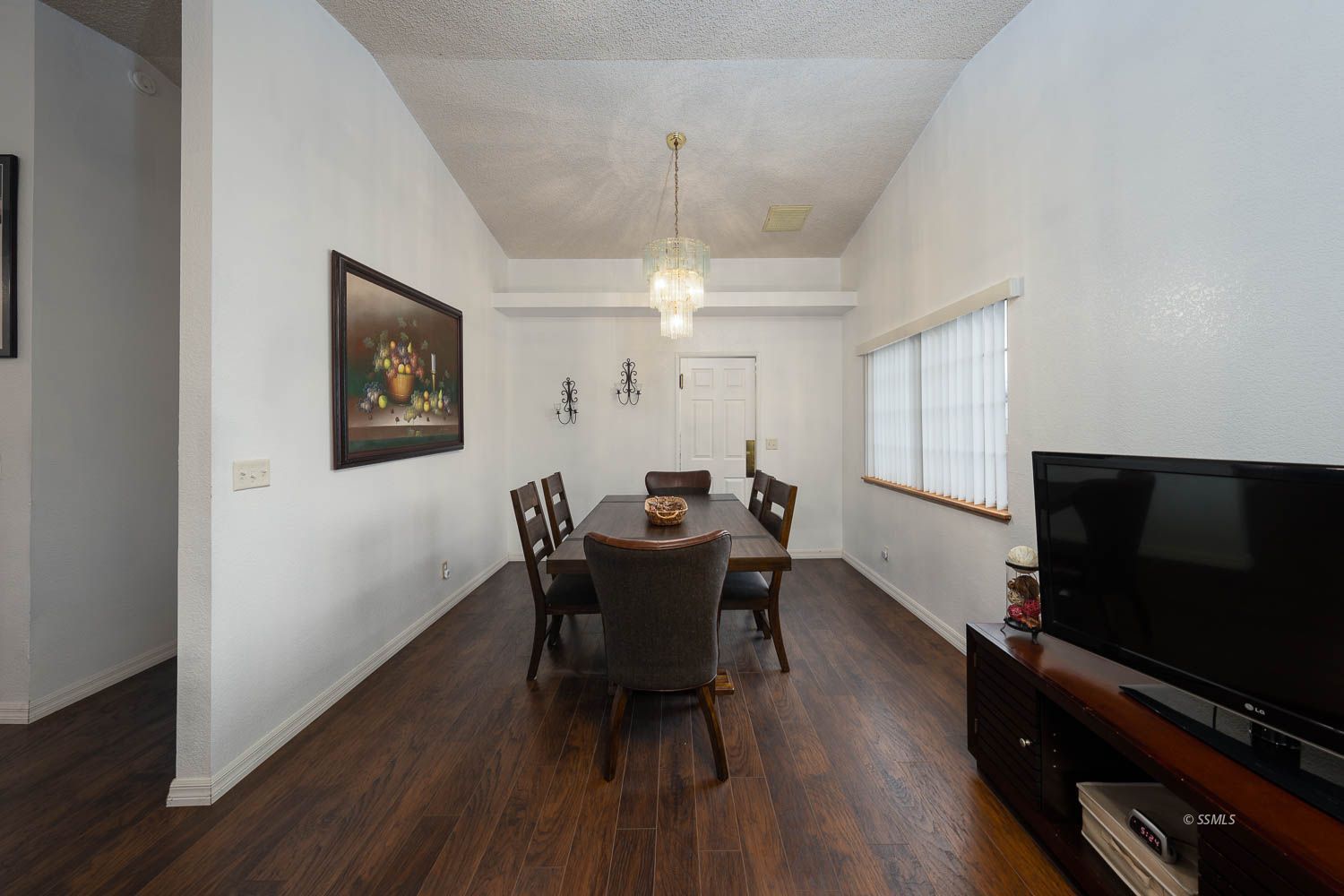 800 Valarie Street Ridgecrest, CA 93555 - Photo 6 of 39 a dining room with furniture a chandelier and wooden floor