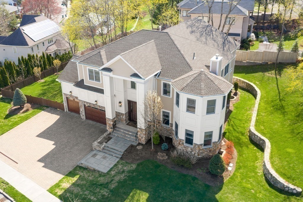 an aerial view of a house with a yard table and chairs