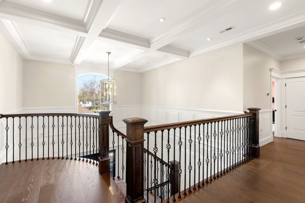 9 Nardell Road Newton, MA 02459 - Photo 17 of 32 a view of a hallway with wooden floor and a chandelier