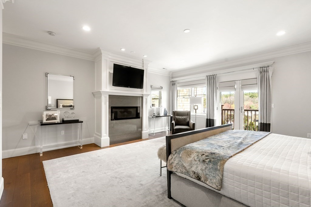 9 Nardell Road Newton, MA 02459 - Photo 18 of 32 a bedroom with a bed and a television