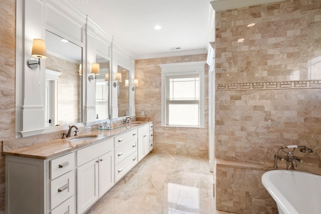 9 Nardell Road Newton, MA 02459 - Photo 21 of 32 a bathroom with double vanity sinks a large mirror and a bathtub