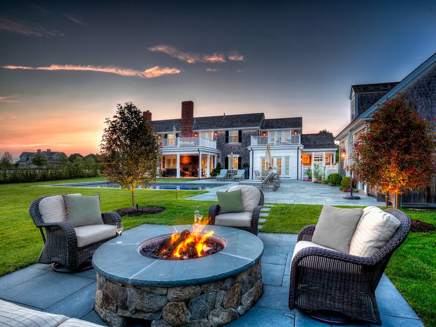 a view of a patio with couches chairs and a fire pit