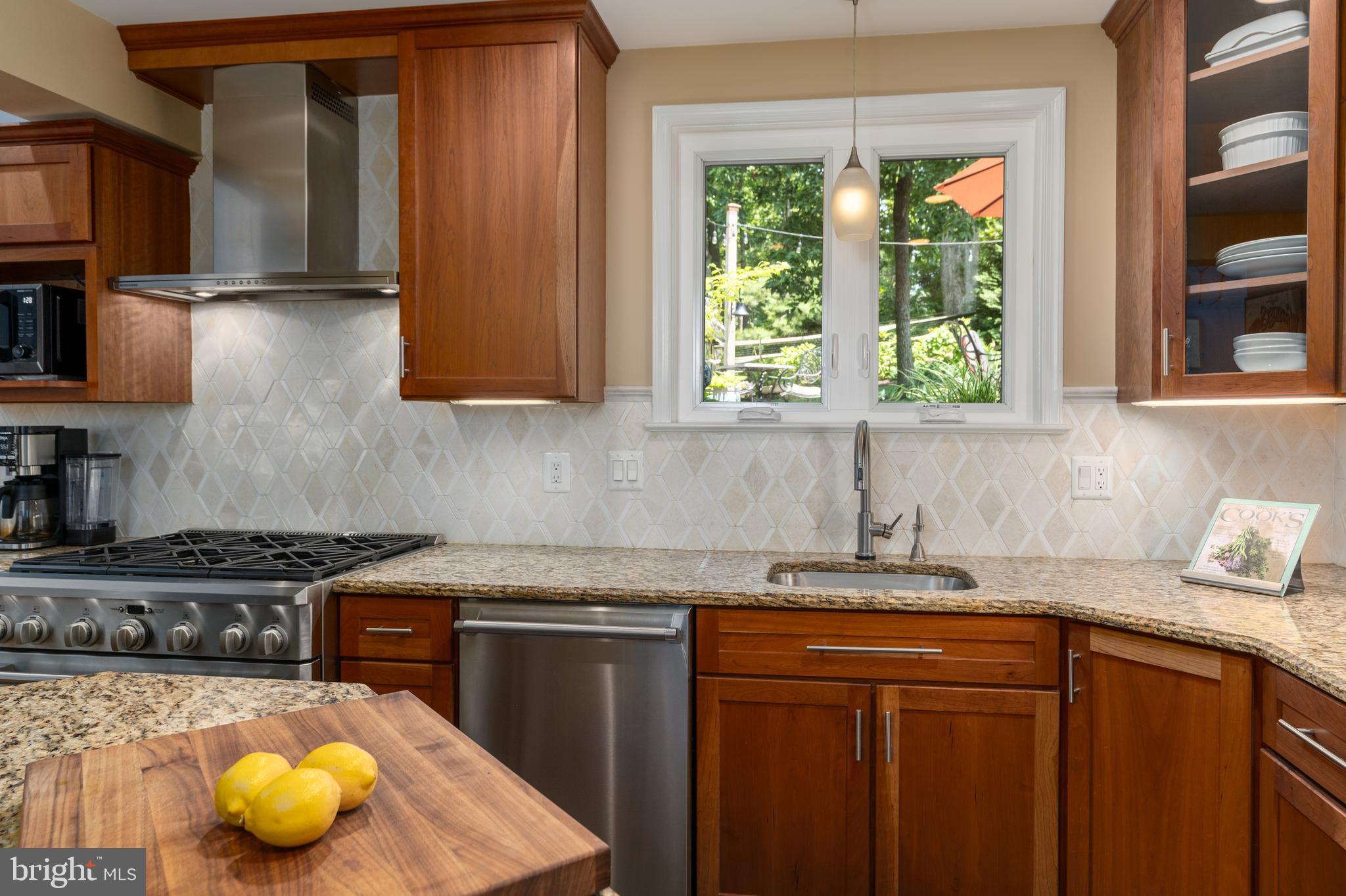 7303 Fort Hunt Road Alexandria, VA 22307 - Photo 4 of 9 a kitchen with stainless steel appliances granite countertop a sink a stove cabinets and a window