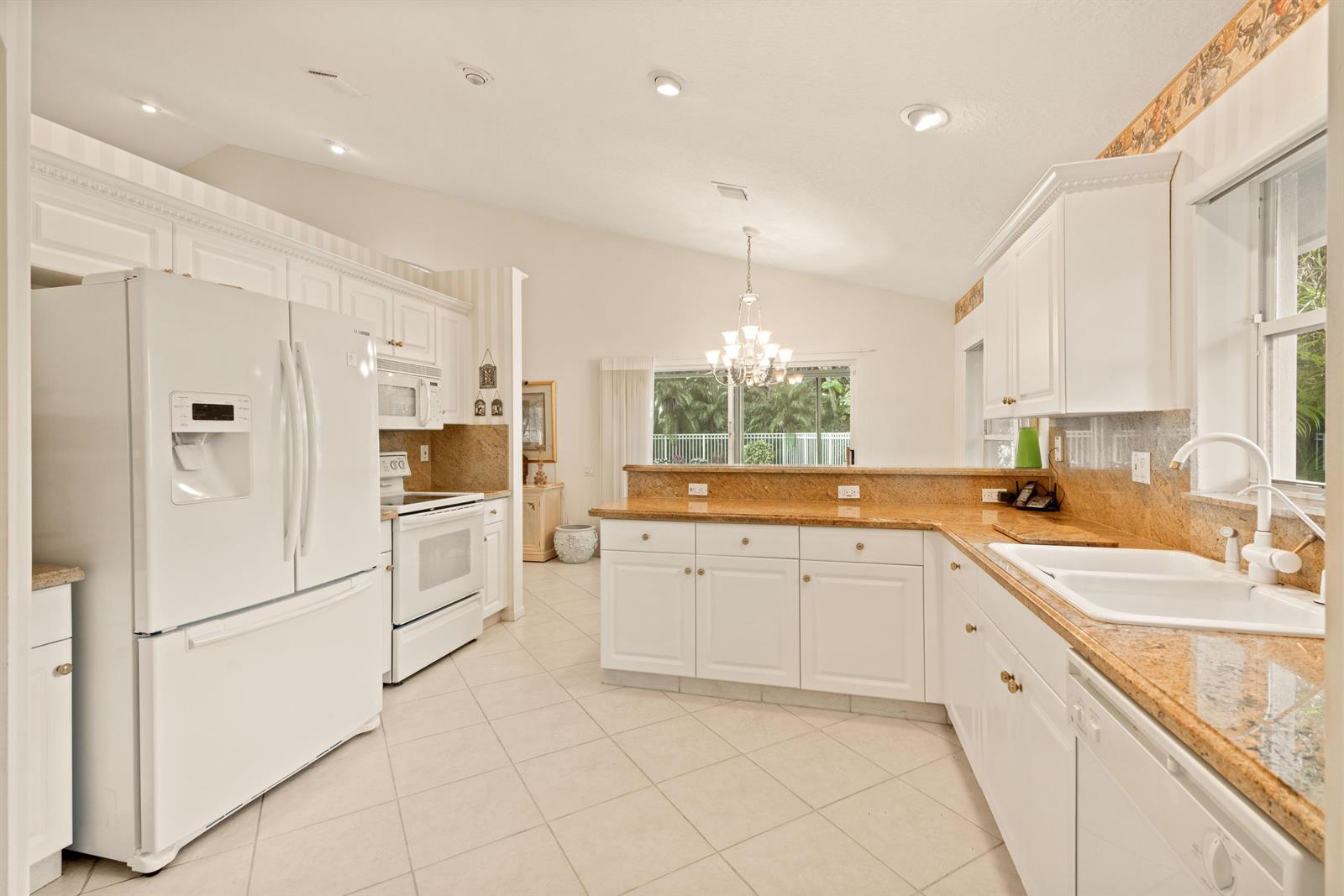 7386 Falls Road East Boynton Beach, FL 33437 - Photo 9 of 32 Kitchen to Pool