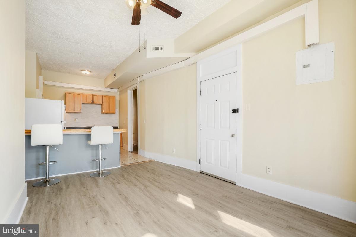 471 Florida Avenue Northwest, Unit 1 Washington, DC 20001 - Photo 11 of 39 a view of a kitchen with furniture and a ceiling fan