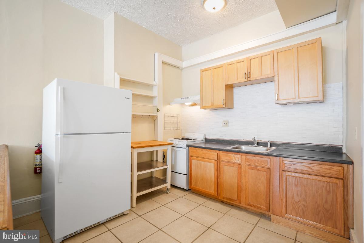 471 Florida Avenue Northwest, Unit 1 Washington, DC 20001 - Photo 13 of 39 a kitchen with white cabinets and white appliances
