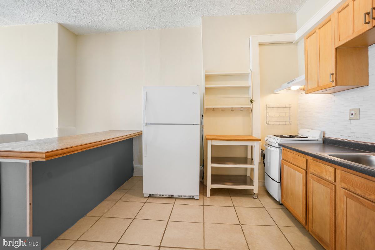 471 Florida Avenue Northwest, Unit 1 Washington, DC 20001 - Photo 14 of 39 a kitchen with granite countertop cabinets and appliances
