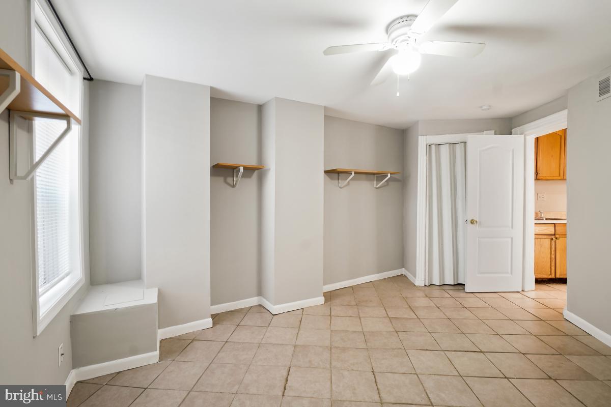 471 Florida Avenue Northwest, Unit 1 Washington, DC 20001 - Photo 19 of 39 a view of an empty room with window and chandelier fan