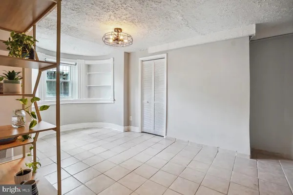 a bathroom with a toilet a sink a mirror and vanity