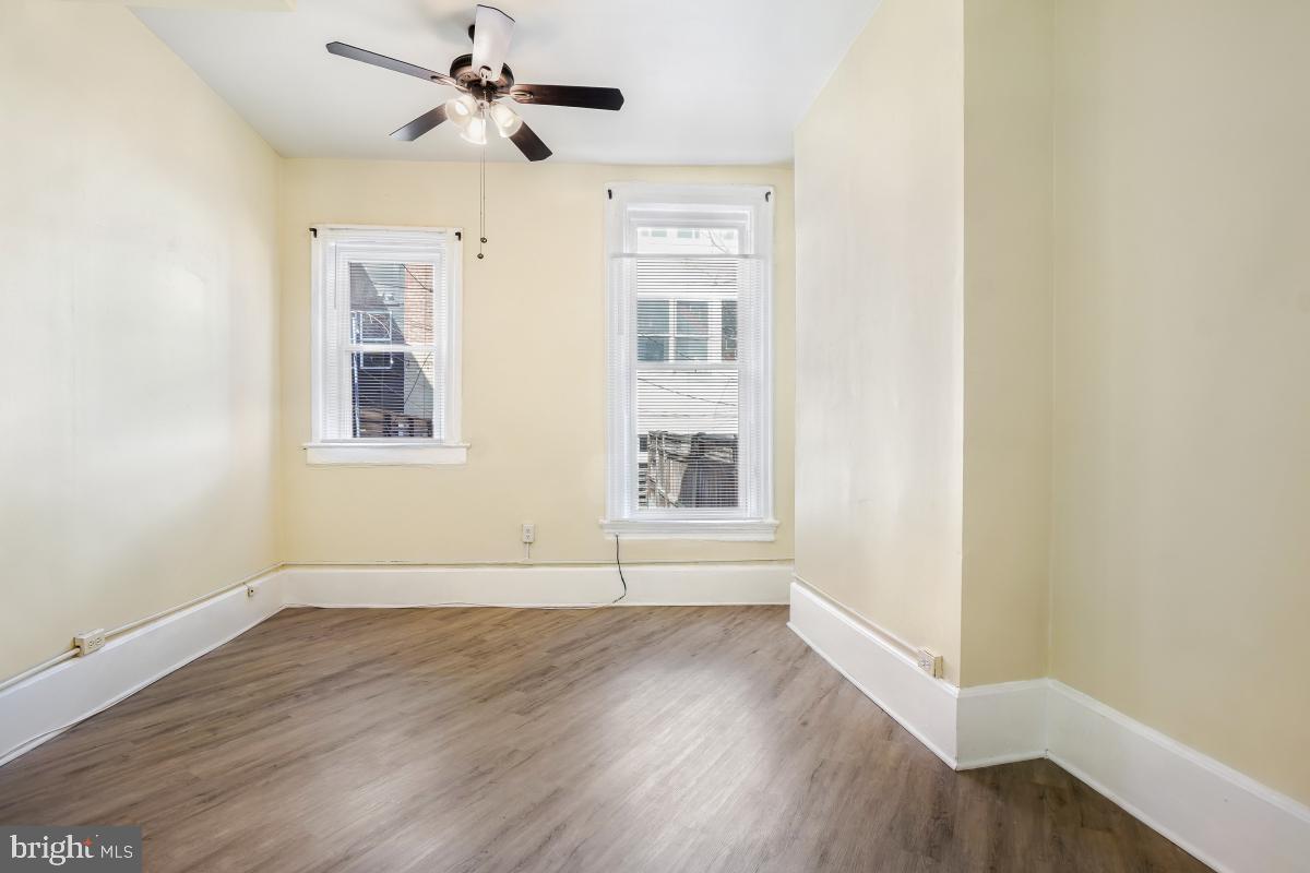 471 Florida Avenue Northwest, Unit 1 Washington, DC 20001 - Photo 29 of 39 an empty room with wooden floor ceiling fan and windows