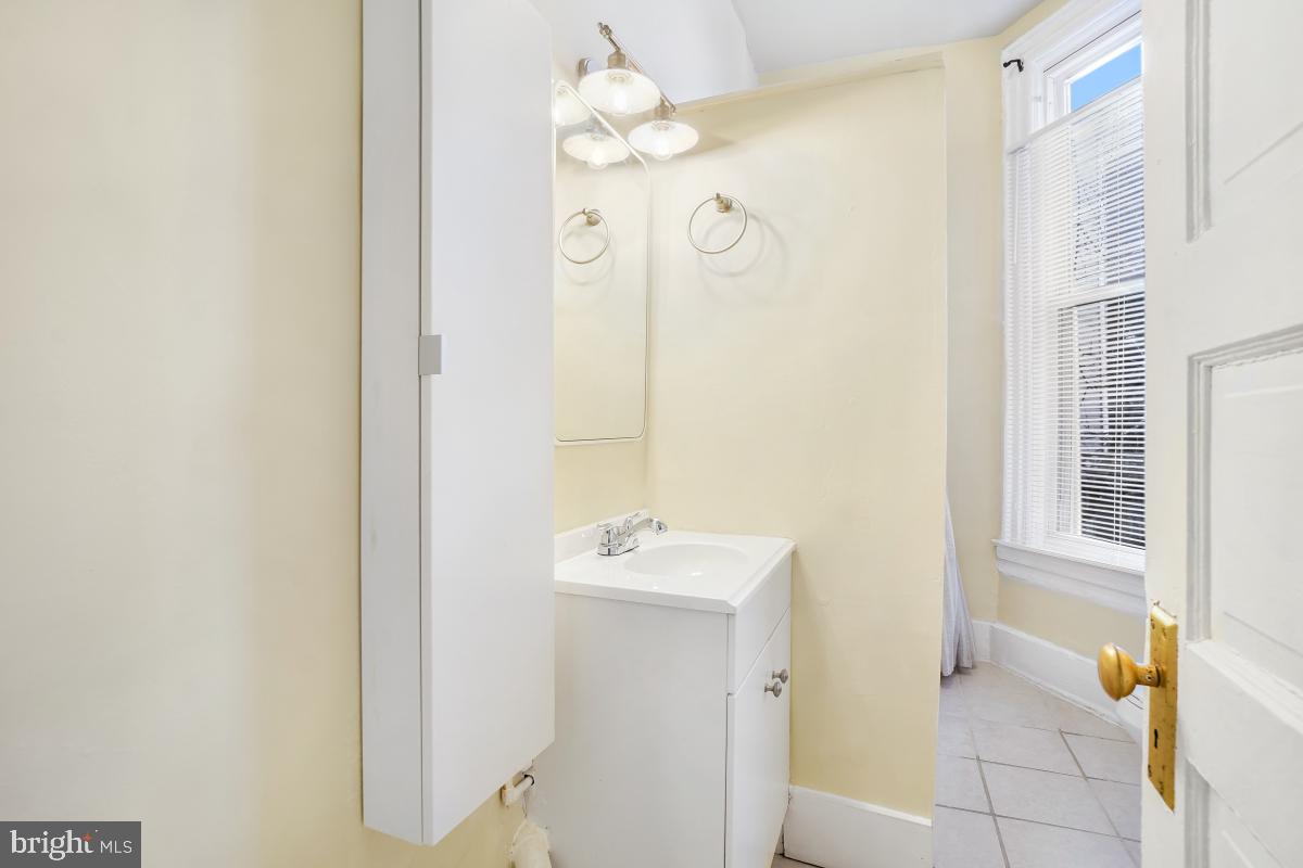 471 Florida Avenue Northwest, Unit 1 Washington, DC 20001 - Photo 34 of 39 a bathroom with a sink a mirror and a shower