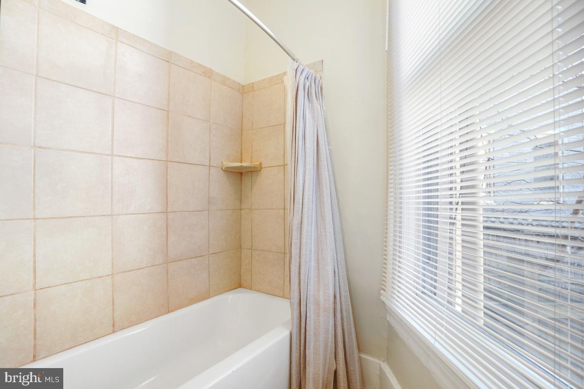 471 Florida Avenue Northwest, Unit 1 Washington, DC 20001 - Photo 37 of 39 a bathroom with a bathtub and shower