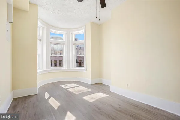 a view of a room with wooden floor and windows