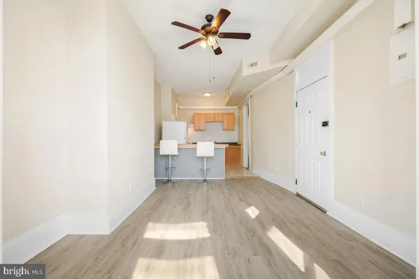 a view of a kitchen with furniture and a ceiling fan
