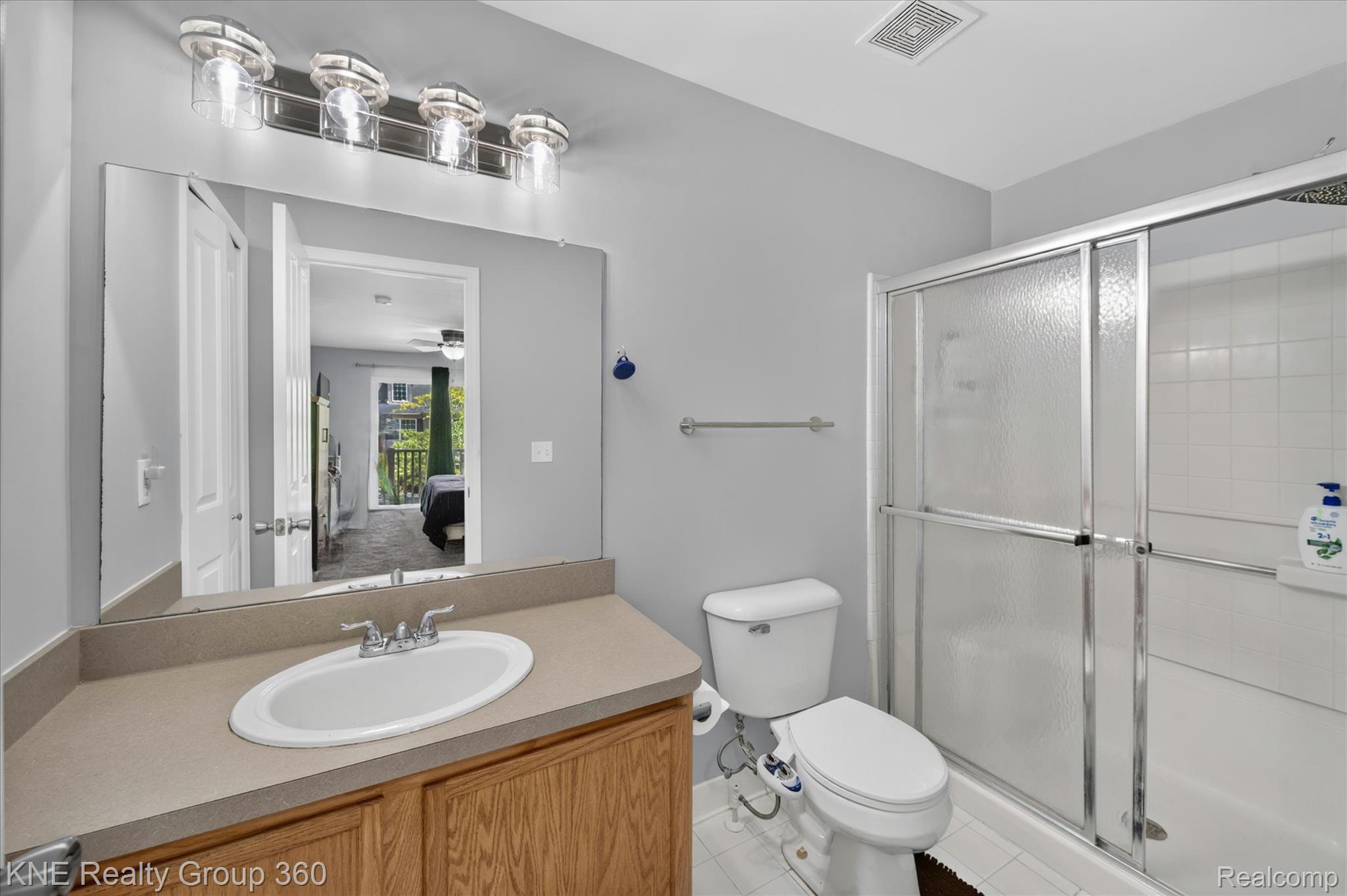 4077 Berkeley Avenue Canton, MI 48188 - Photo 21 of 32 Full bathroom featuring a single vanity with an oval basin, a light-toned countertop, and wood-finish cabinetry