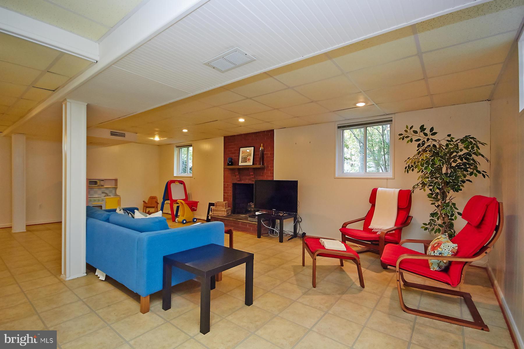413 Branch Road Southeast Vienna, VA 22180 - Photo 22 of 30 a living room with furniture and a flat screen tv
