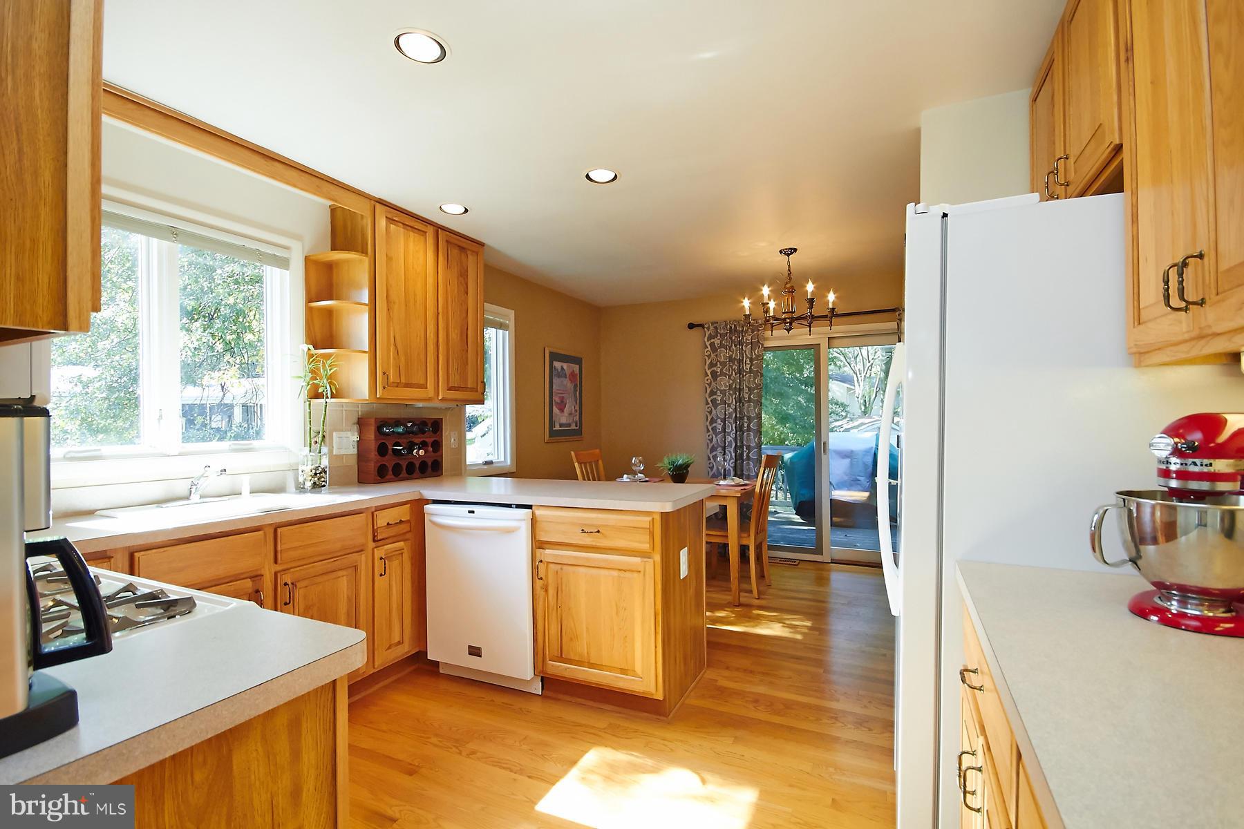 413 Branch Road Southeast Vienna, VA 22180 - Photo 8 of 30 a kitchen with a stove a refrigerator and a view of living room